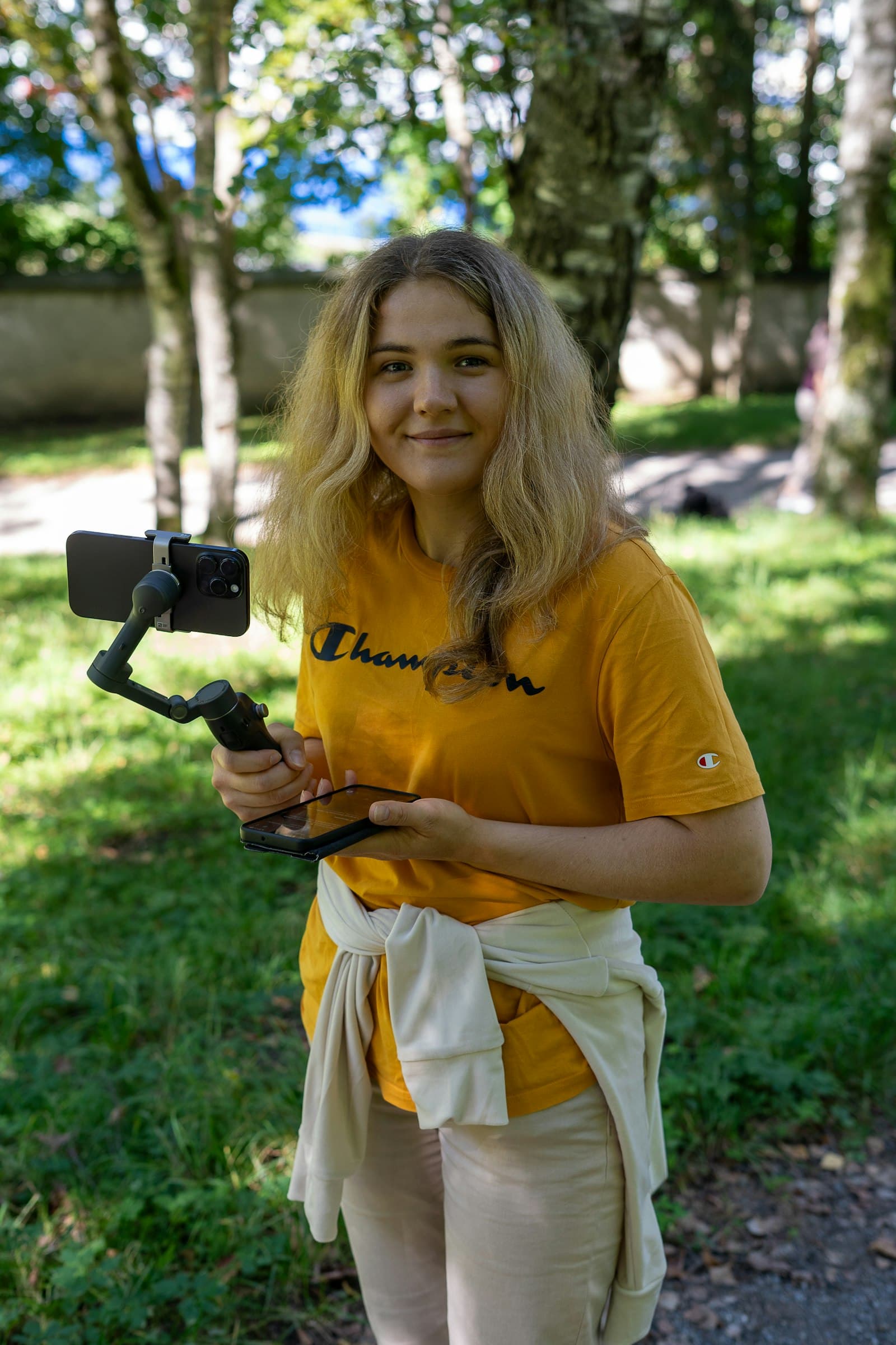 Creator filming outdoors with a phone on a gimbal